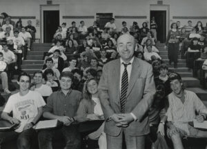man standing in front of smiling students