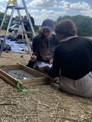 A photo of Alyssa Bolster, BA’22, on-site with a volunteer from Austria.