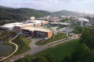 Aerial view of the Oak Ridge National Laboratory: several brick buildings in a mountainous setting