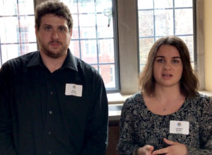 Adam Gottlieb and Caroline Kohler standing in exhibit hall talking about thier celebration of learning project