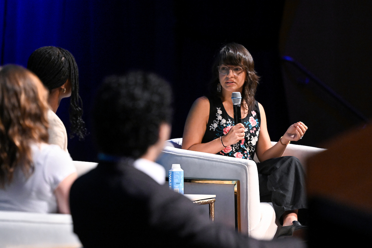 Mónica Guzmán speaking on stage