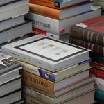 Books in a pile for Afterthoughts: Book Club, a Special Interest Group at OLLI.