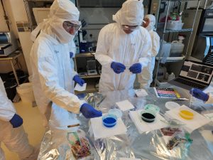 Summit High School students and chaperones in cleanroom suites participating in the Microfluidics Lab outreach field trip on February 6, 2026.