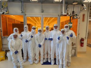 Summit High School students and chaperones pose in cleanroom suites during the Microfluidics Lab outreach field trip on February 6, 2026.