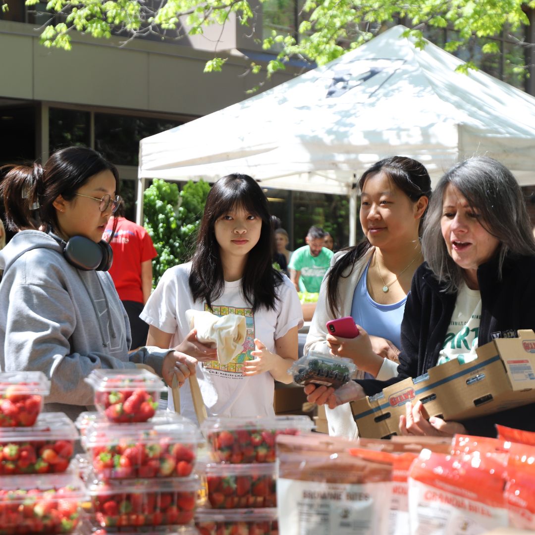 Pictured: Vanderbilt students gather at the Campus Dining Rand Farmers Market to shop for strawberries.